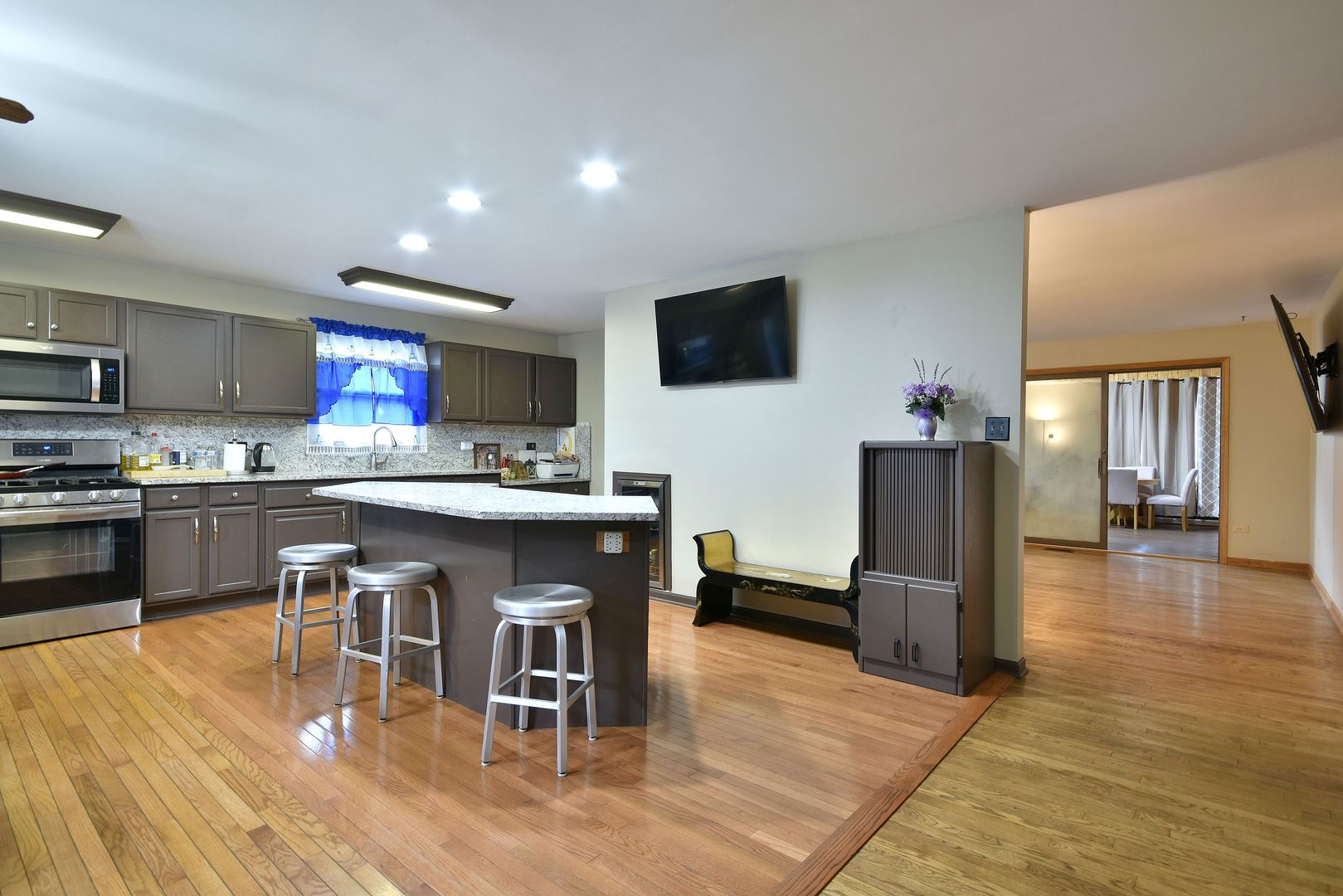 9N590 Flora Drive Elgin, IL 60123 - Photo 4 of 31 a kitchen with stainless steel appliances granite countertop a table chairs refrigerator and a sink