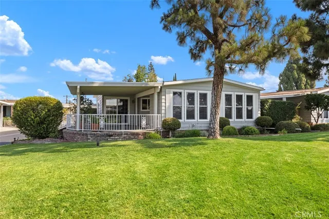a view of a house with a backyard porch and sitting area