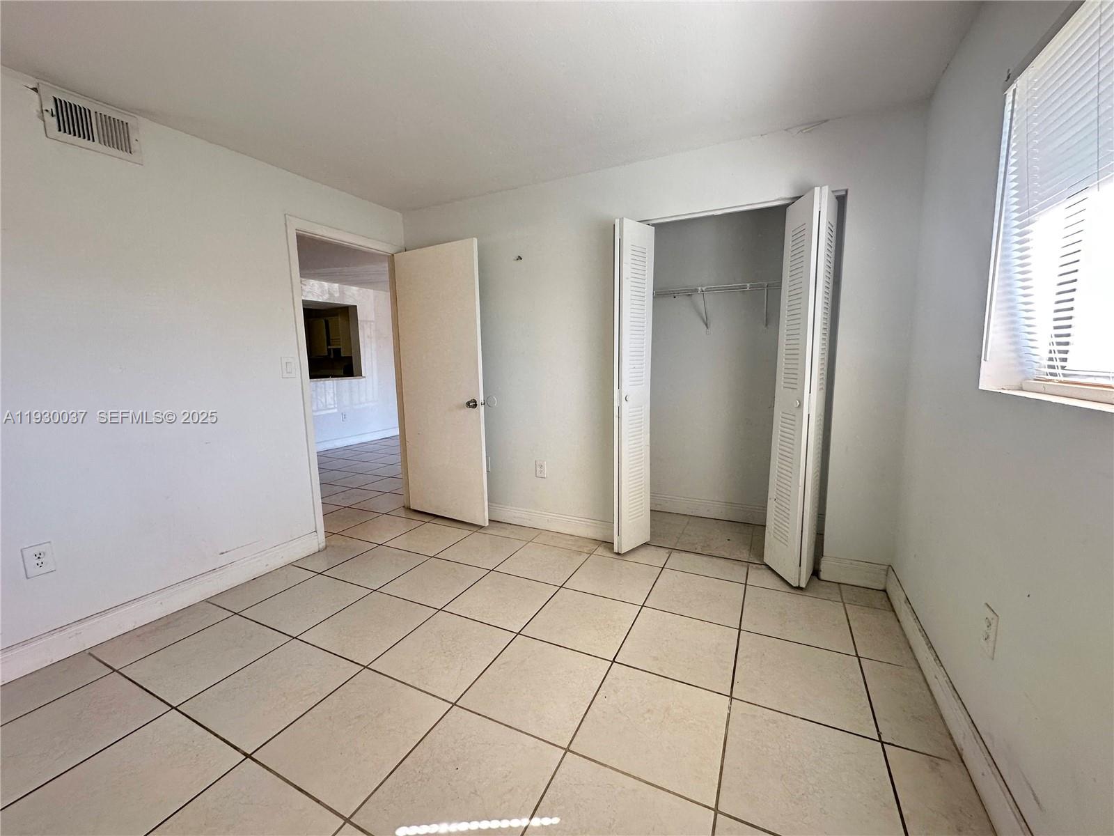 301 Palm Way, Unit 206 Pembroke Pines, FL 33025 - Photo 11 of 23 a view of a livingroom with an empty space and a window