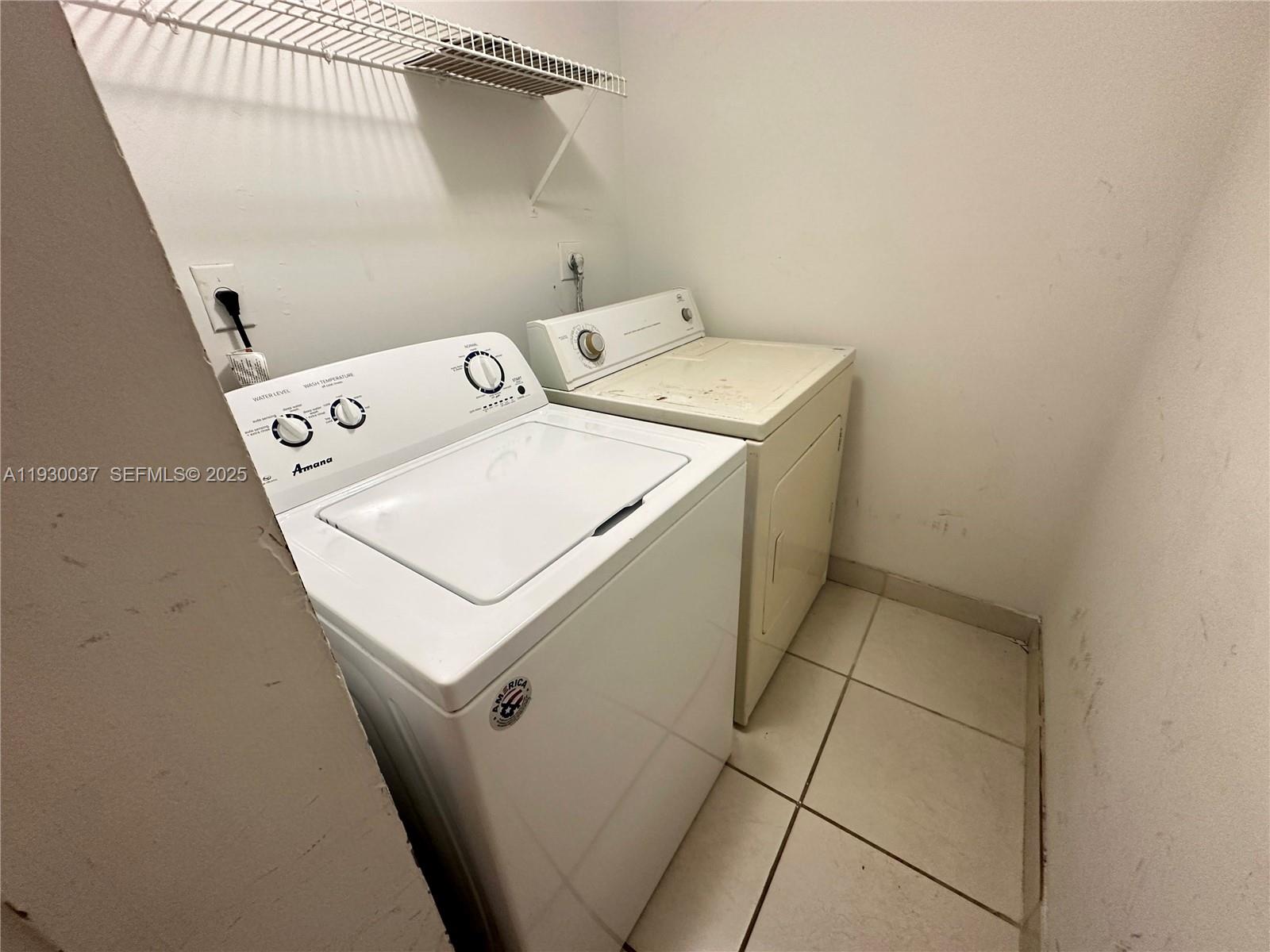 301 Palm Way, Unit 206 Pembroke Pines, FL 33025 - Photo 12 of 23 a utility room with dryer and washer