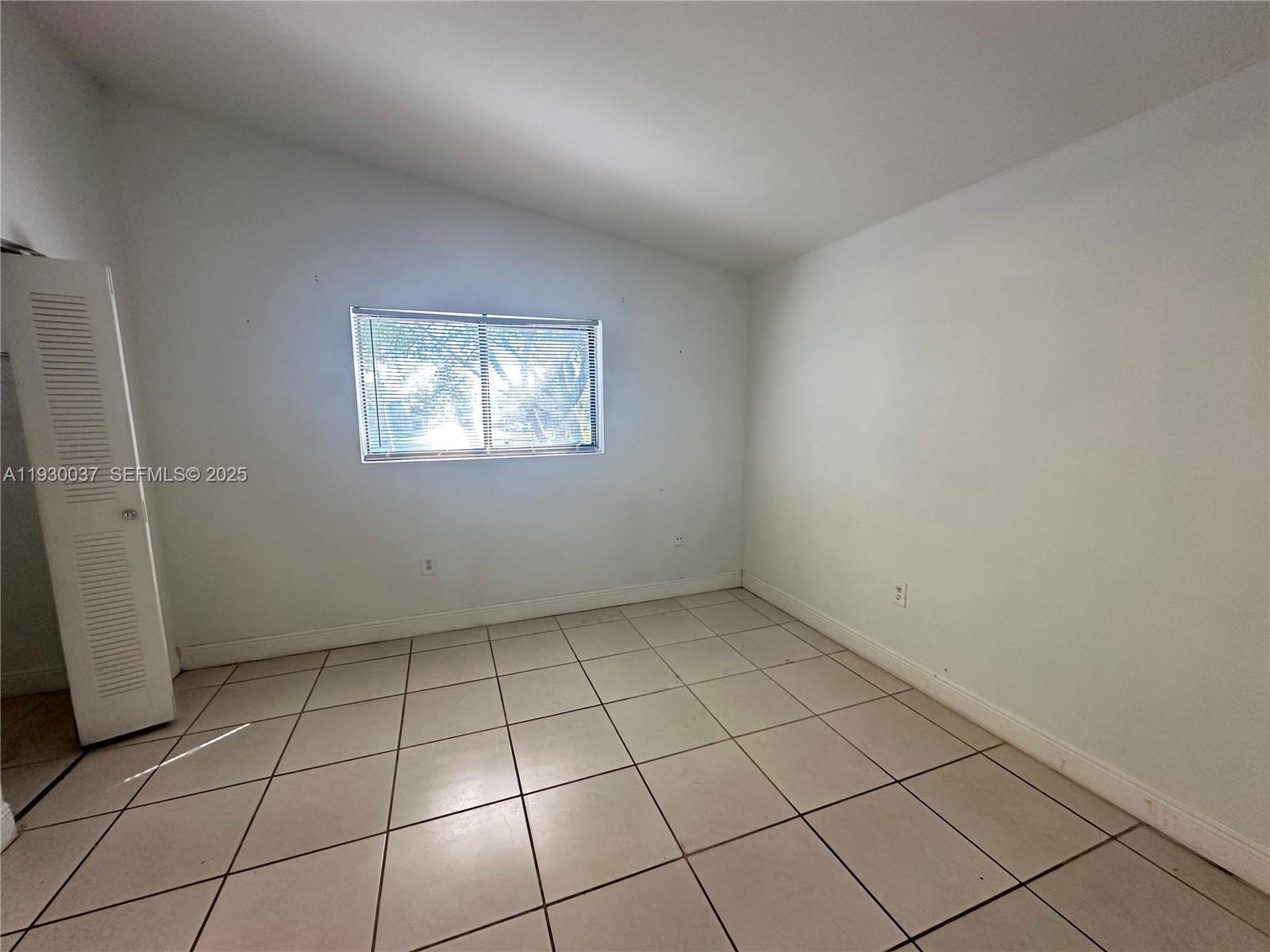 301 Palm Way, Unit 206 Pembroke Pines, FL 33025 - Photo 15 of 23 a view of an empty room and window
