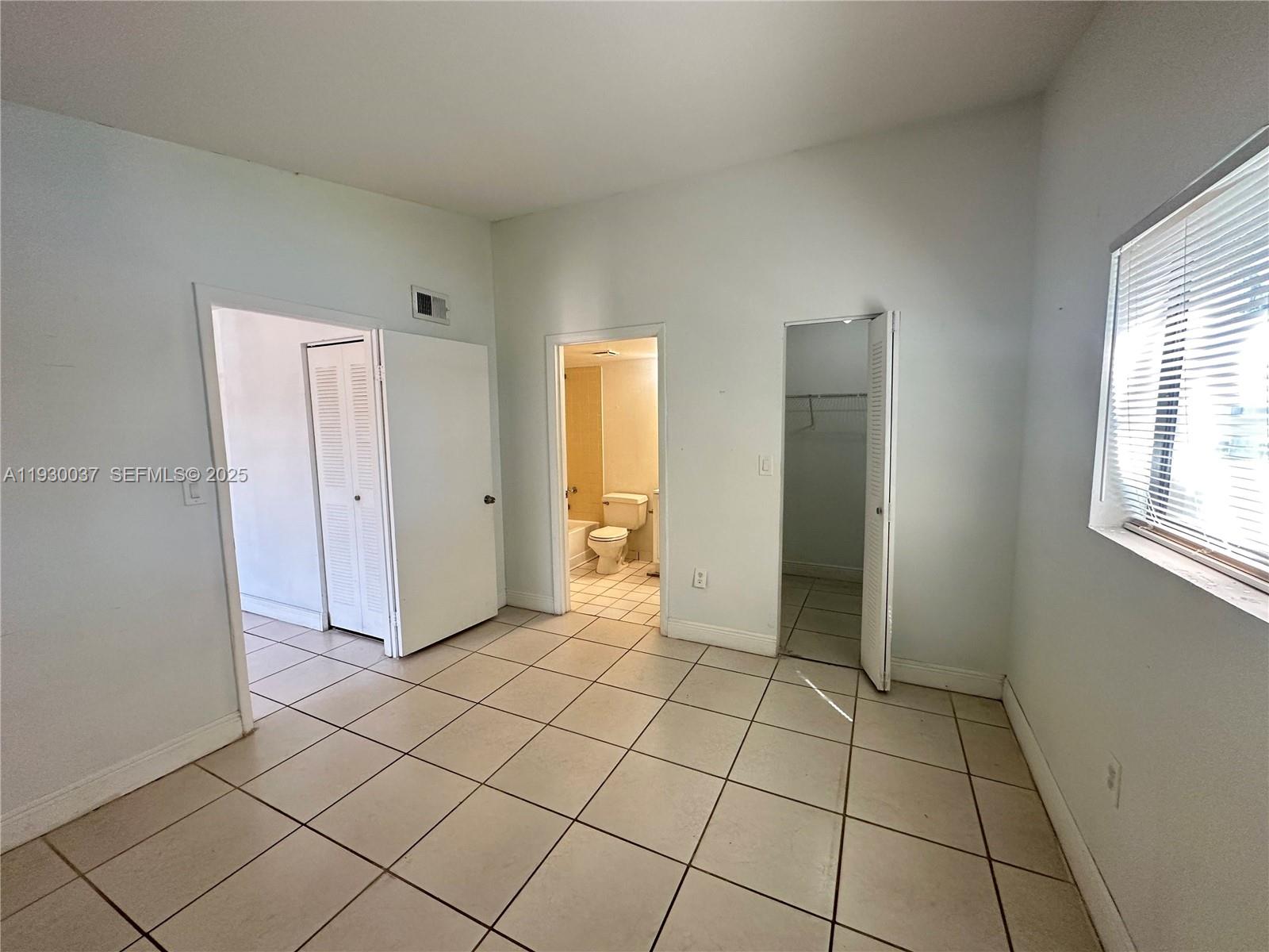 301 Palm Way, Unit 206 Pembroke Pines, FL 33025 - Photo 18 of 23 a view of an empty room and window