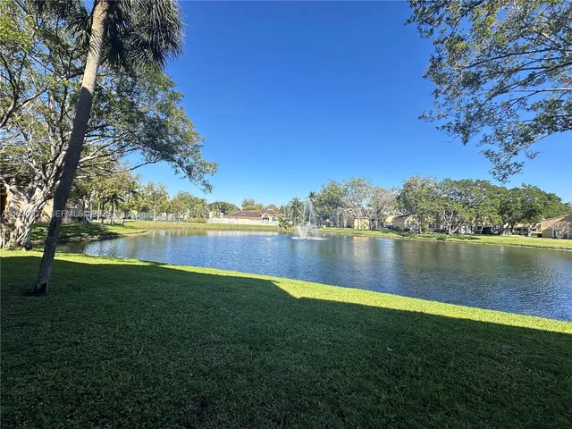 a view of a lake with houses in the back