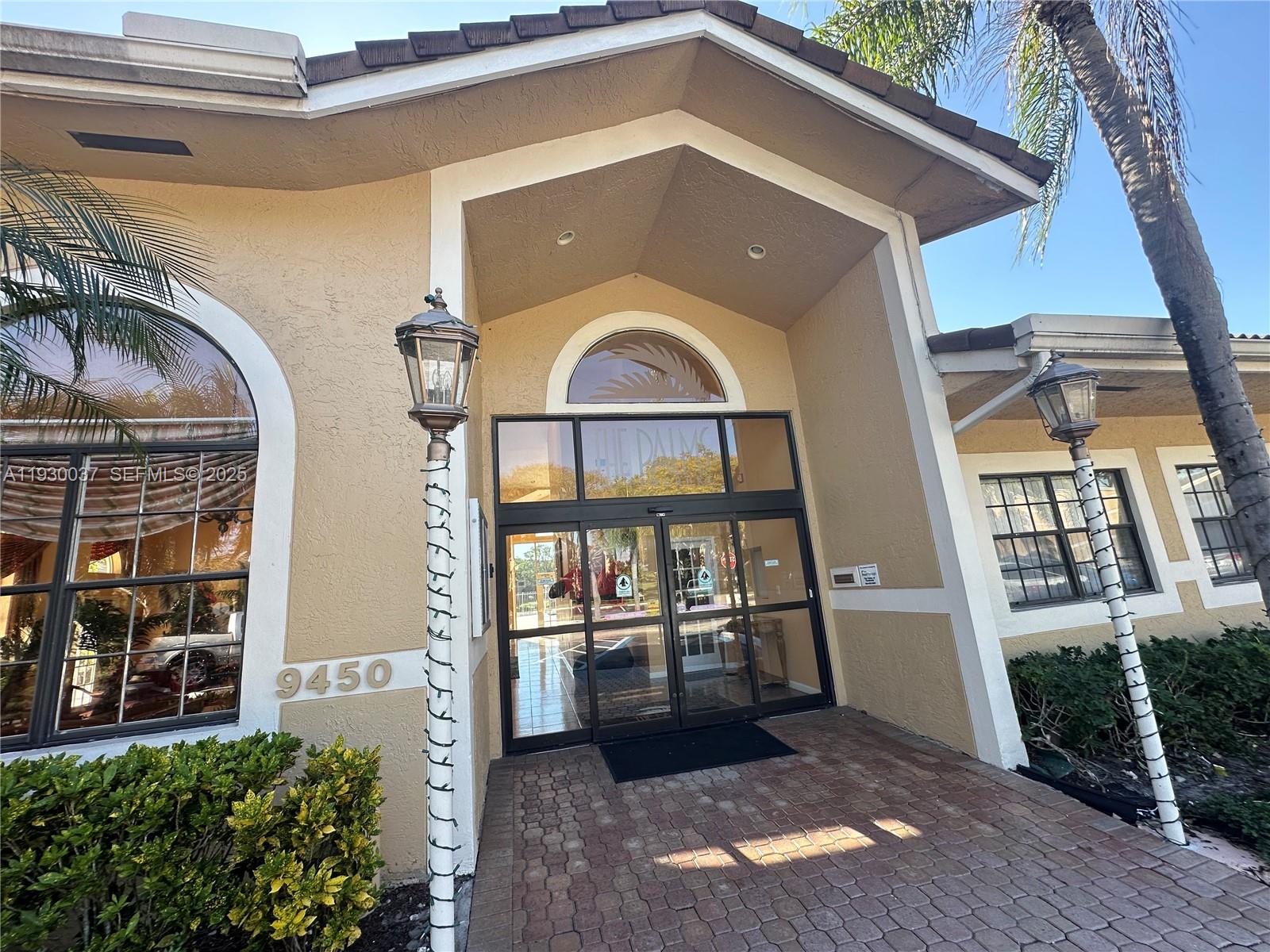 301 Palm Way, Unit 206 Pembroke Pines, FL 33025 - Photo 23 of 23 a front view of a house with a yard