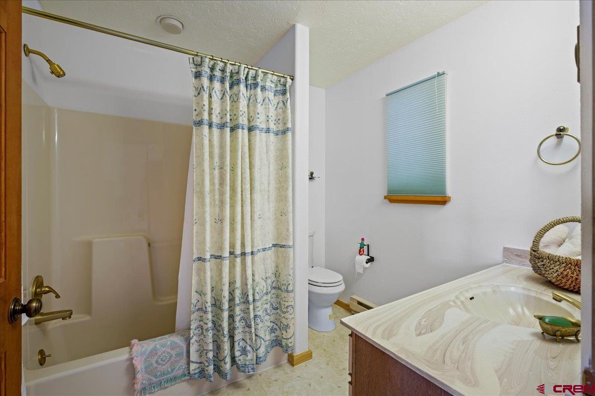 12979 County Road 1 Ridgway, CO 81432 - Photo 20 of 35 a bathroom with a sink toilet and shower