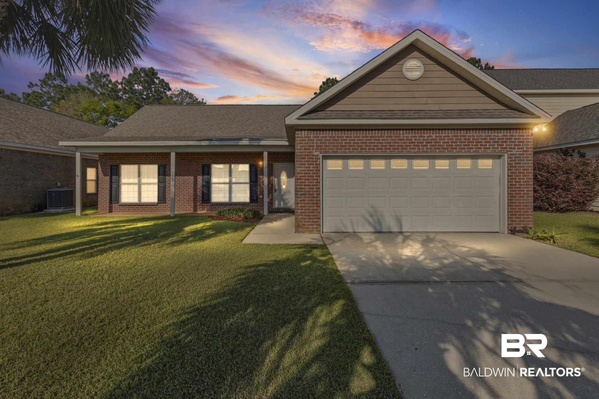 1153 Sloane Cove Foley, AL 36535 - Photo 3 of 25 Ranch-style house with a lawn, concrete driveway, a garage, and brick siding