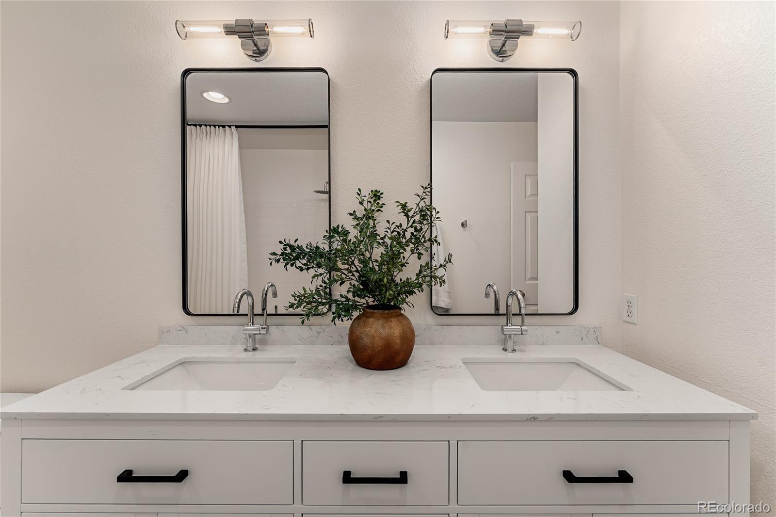 9441 South Hackberry Lane Highlands Ranch, CO 80129 - Photo 37 of 50 a bathroom with double vanity sinks and a mirror
