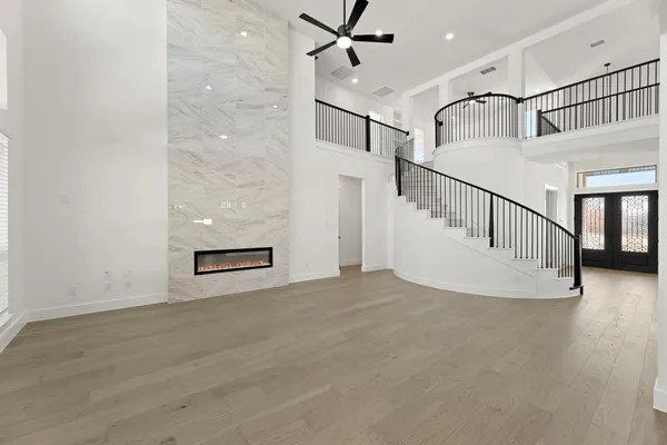 a view of a livingroom with wooden floor and white walls
