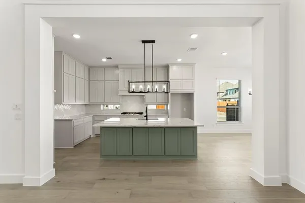 a kitchen with kitchen island a sink stainless steel appliances and cabinets