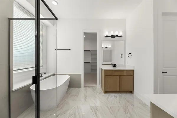 a bathroom with a tub shower and sink
