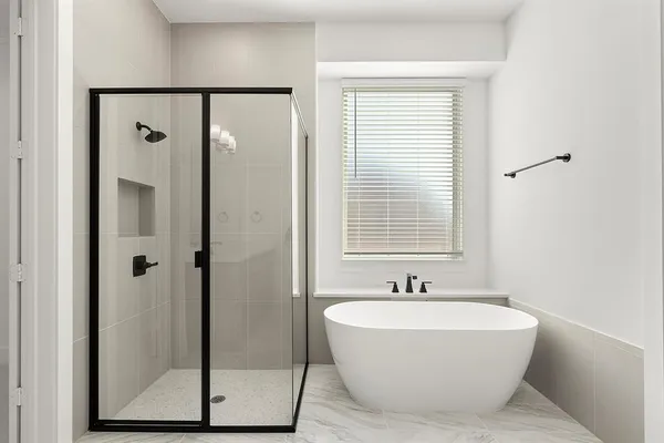 a bathroom with a bathtub and shower