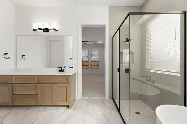 a bathroom with a shower sink and mirror
