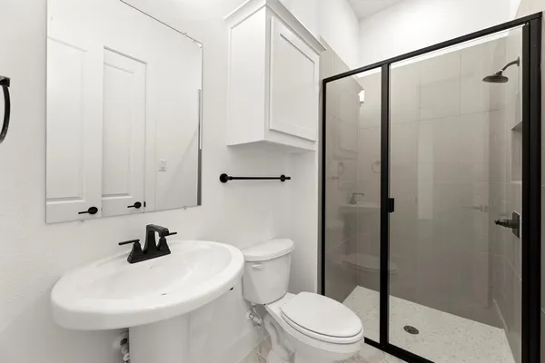 a bathroom with a sink toilet and shower