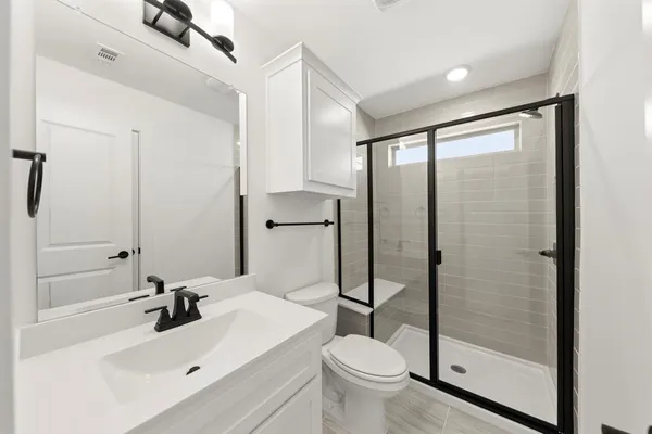 a bathroom with a sink toilet and shower