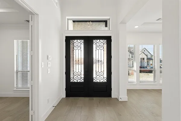 an entryway with wooden floor and a window