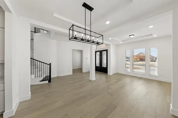 a view of a hallway with wooden floor and entryway