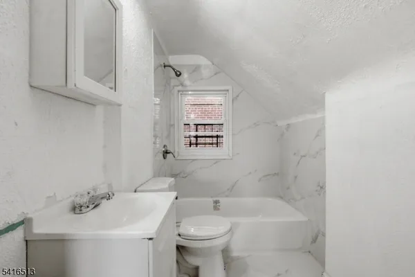 a bathroom with a sink toilet and tub