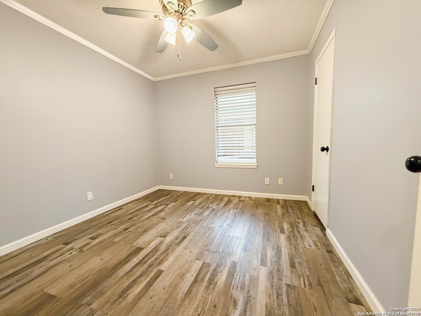 1403 West Hefferman Street Beeville, TX 78102 - Photo 11 of 15 wooden floor in an empty room with a window