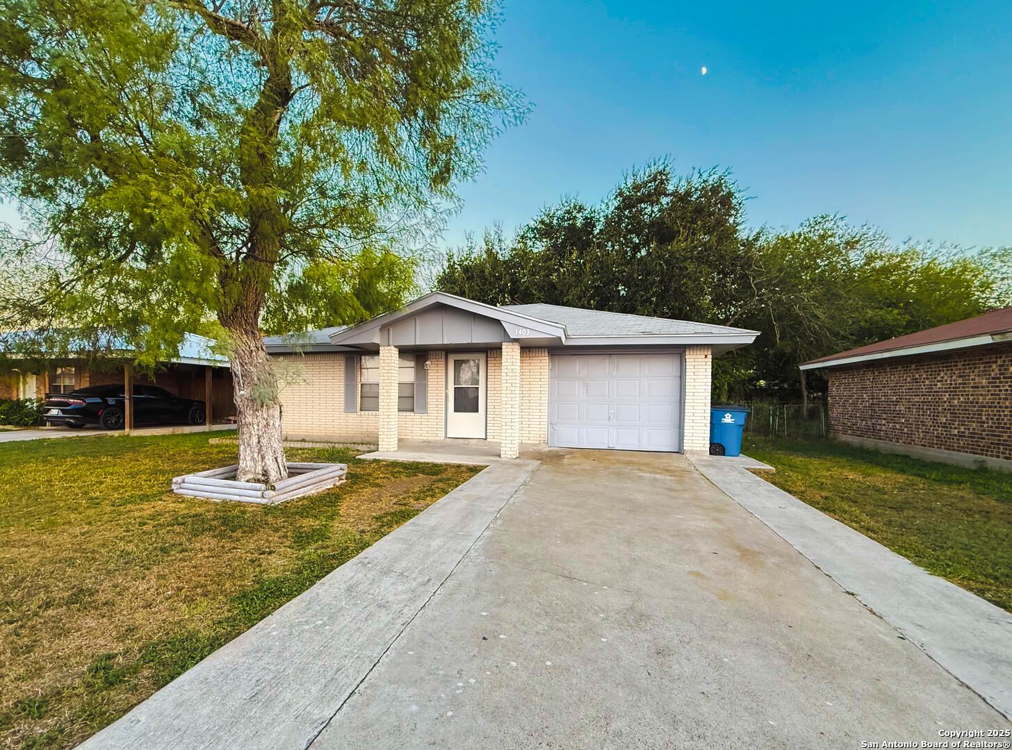 1403 West Hefferman Street Beeville, TX 78102 - Photo 2 of 15 a front view of house with yard garage and green space