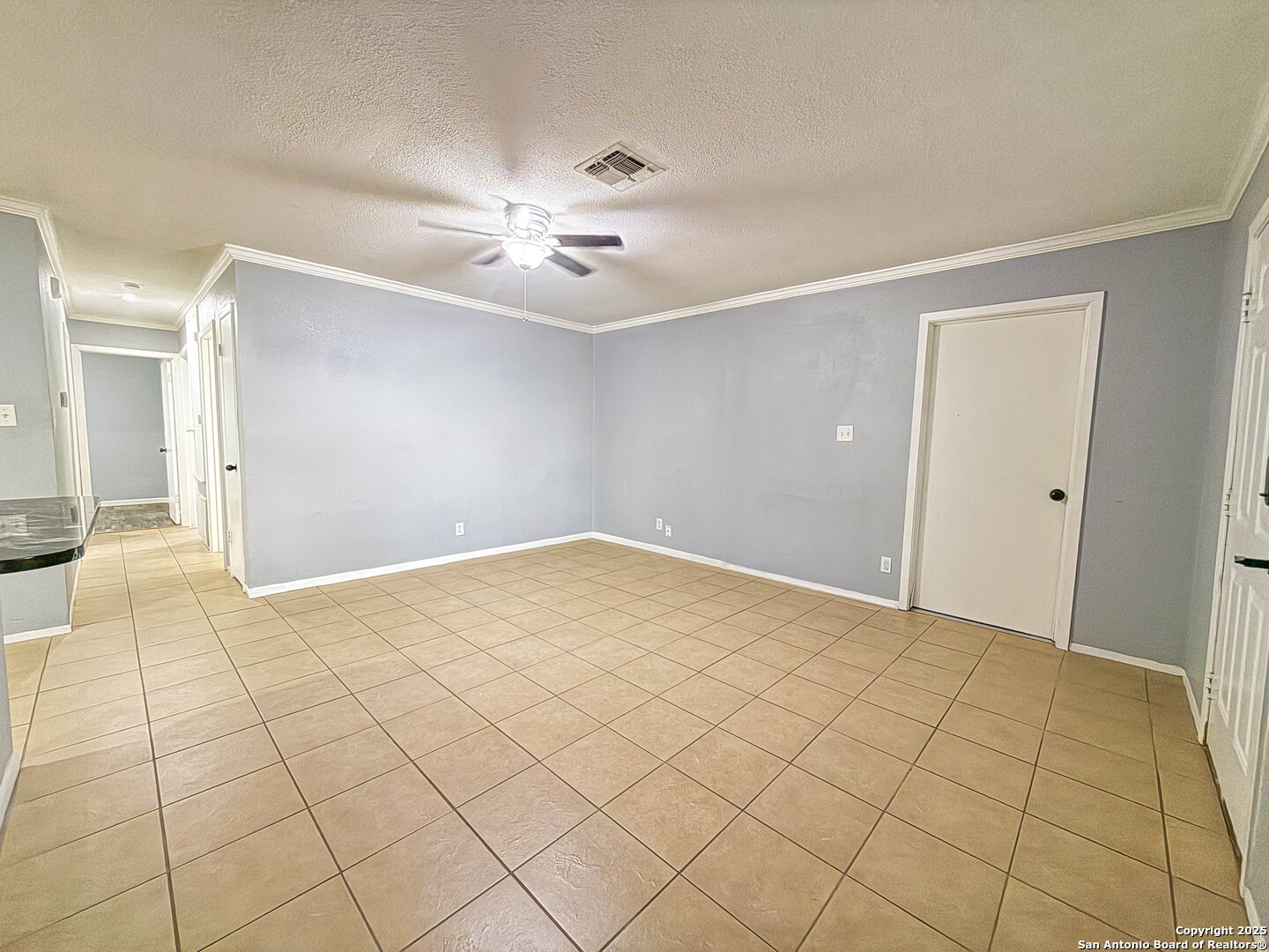 1403 West Hefferman Street Beeville, TX 78102 - Photo 3 of 15 a view of an empty room and a chandelier fan
