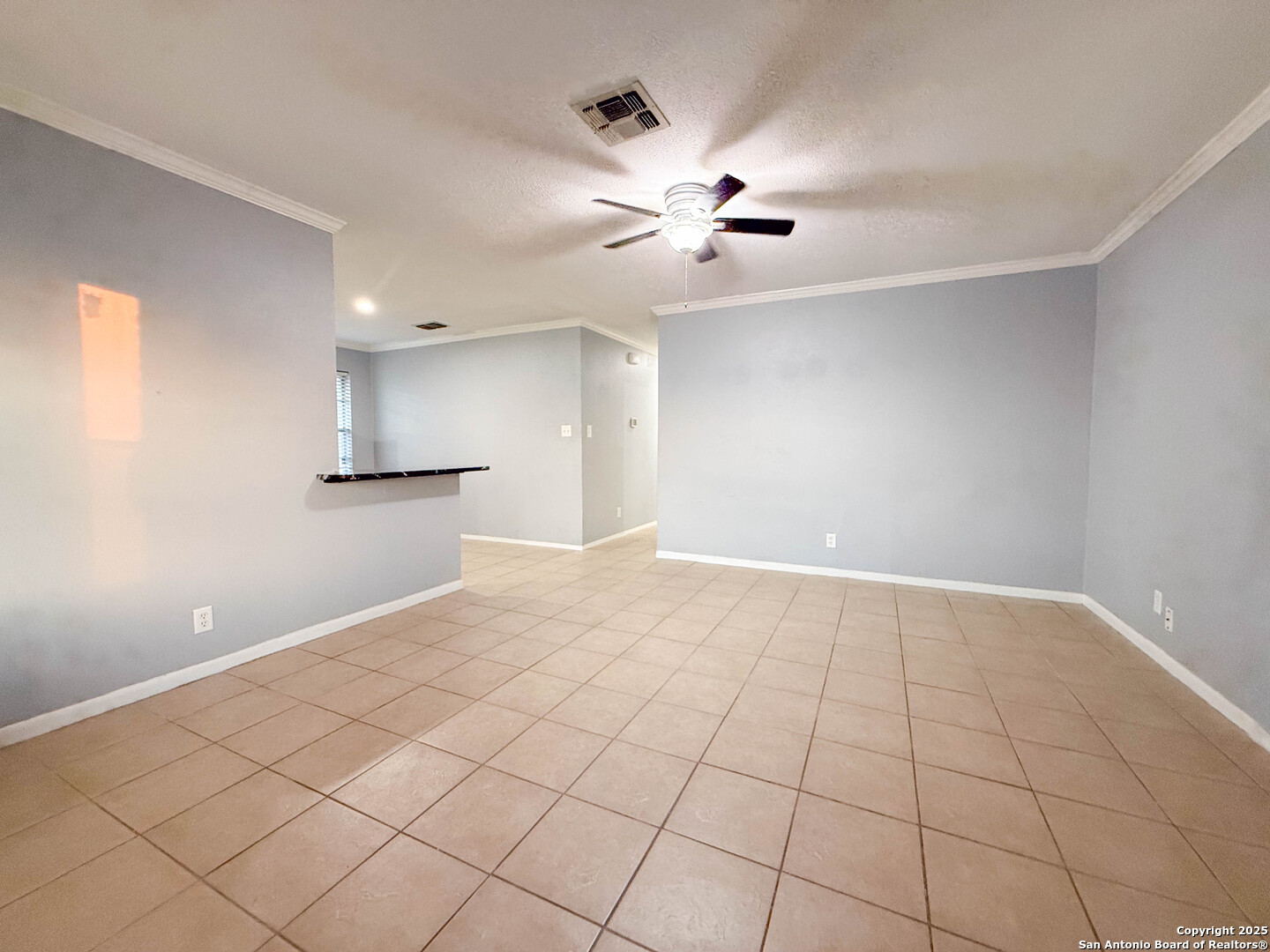 1403 West Hefferman Street Beeville, TX 78102 - Photo 4 of 15 a view of an empty room with a chandelier fan