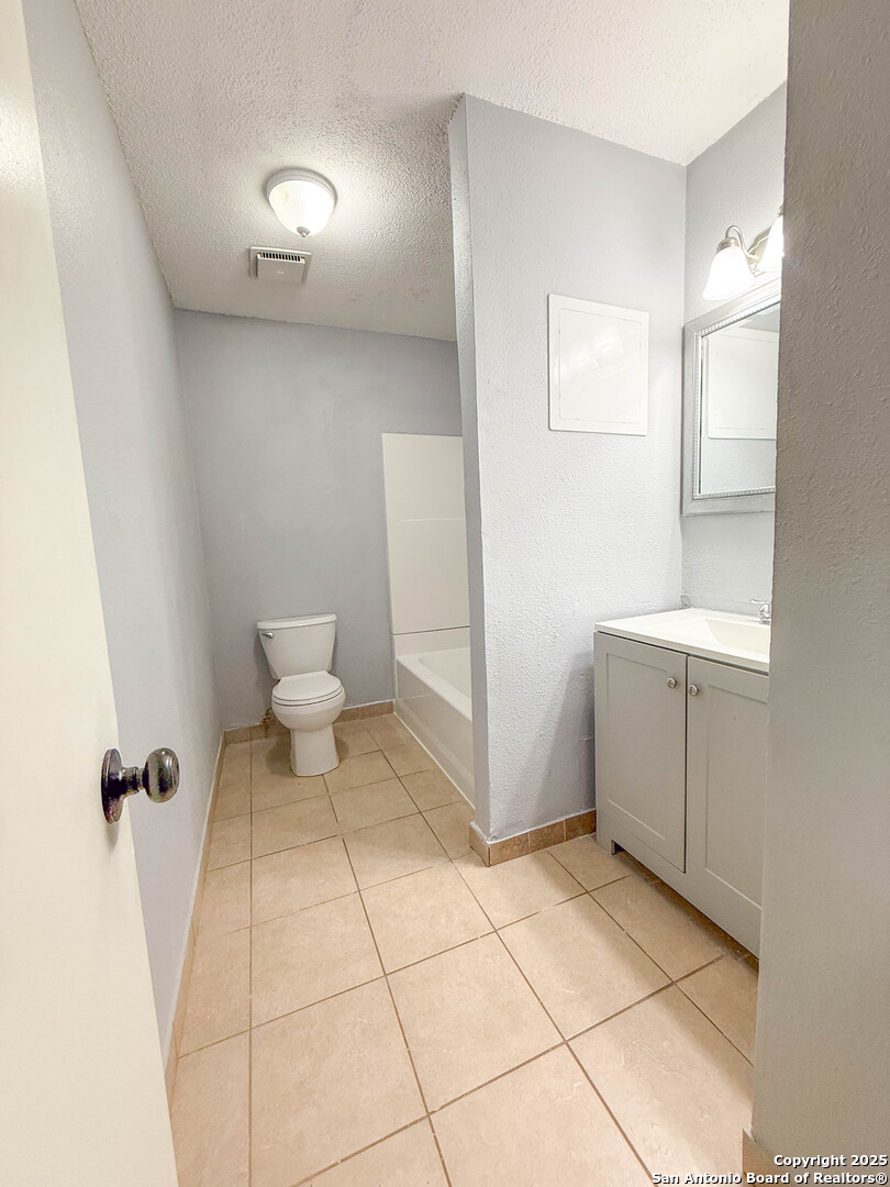1403 West Hefferman Street Beeville, TX 78102 - Photo 8 of 15 a bathroom with a sink toilet and shower