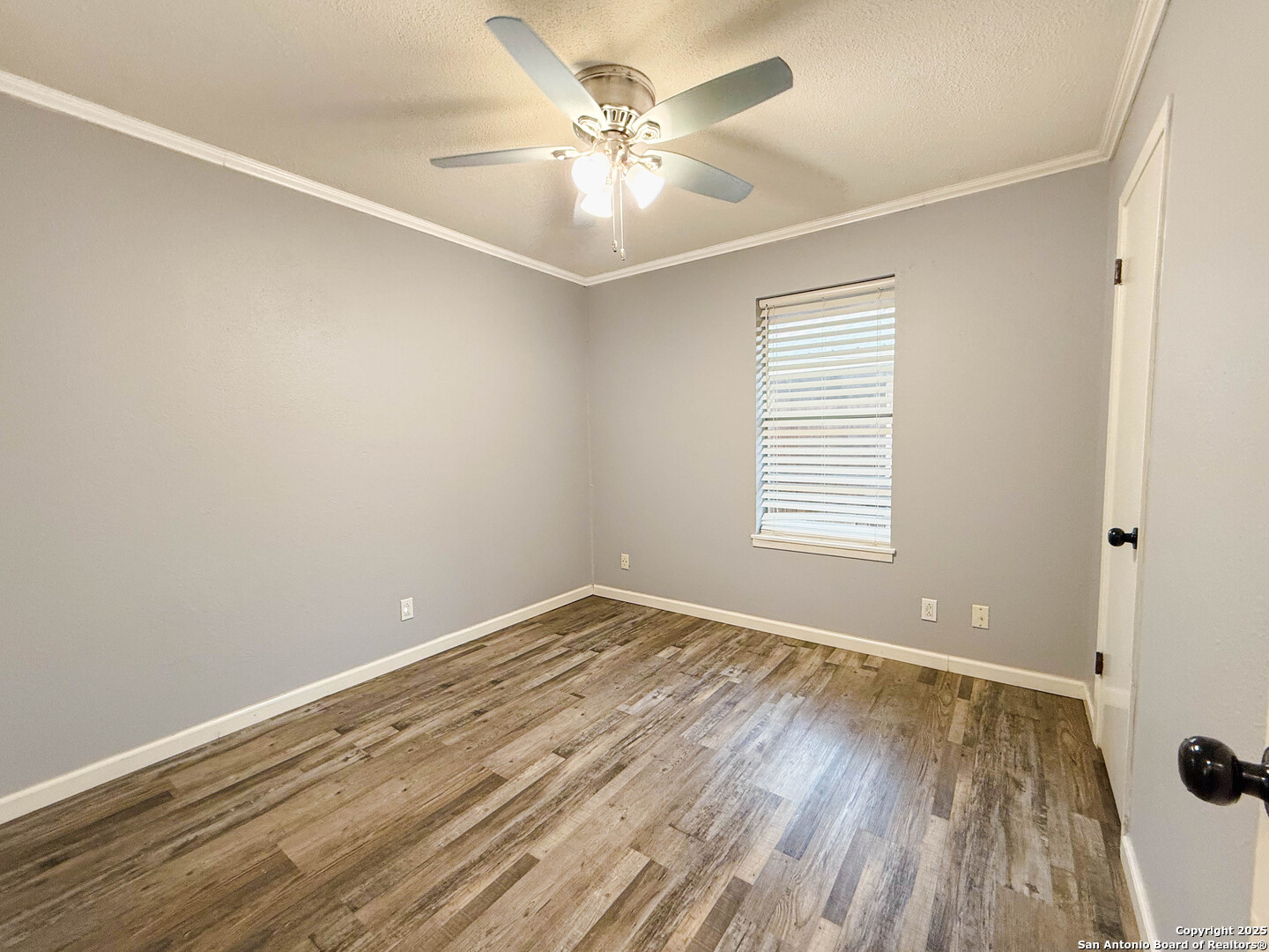 1403 West Hefferman Street Beeville, TX 78102 - Photo 9 of 15 wooden floor in an empty room with a window