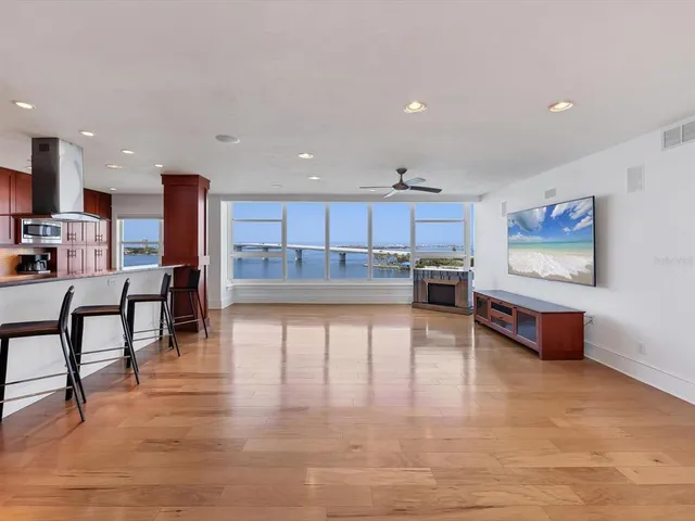 a living room with stainless steel appliances furniture a kitchen view and a kitchen counter top