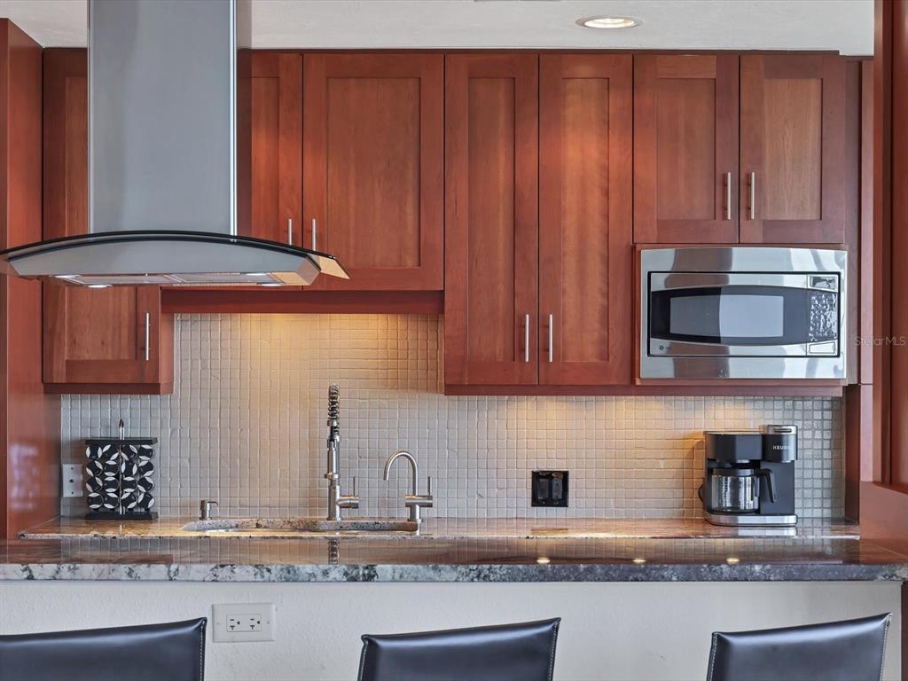 226 Golden Gate Point, Unit 63 Sarasota, FL 34236 - Photo 20 of 48 a kitchen with stainless steel appliances granite countertop a refrigerator and a sink