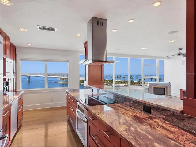 a kitchen with stainless steel appliances granite countertop a sink and a stove
