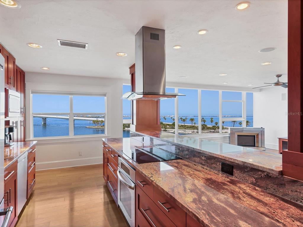226 Golden Gate Point, Unit 63 Sarasota, FL 34236 - Photo 21 of 48 a kitchen with stainless steel appliances granite countertop a sink and a stove