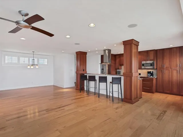 a view of a kitchen with furniture and a refrigerator