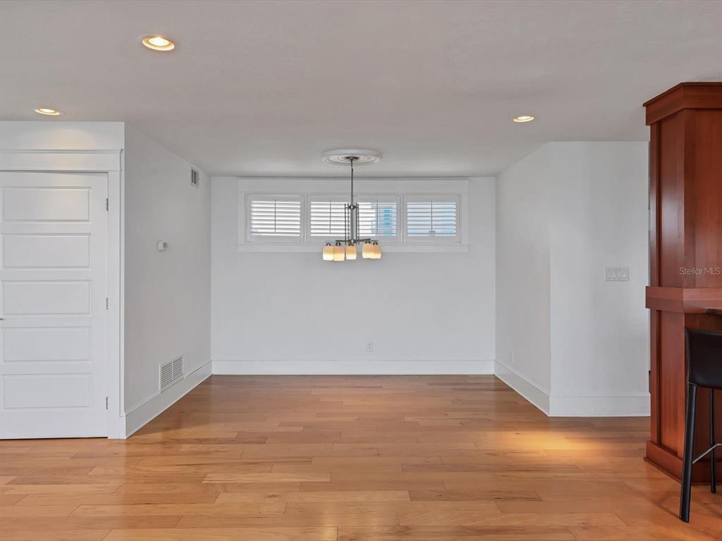 226 Golden Gate Point, Unit 63 Sarasota, FL 34236 - Photo 26 of 48 a view of empty room with wooden floor