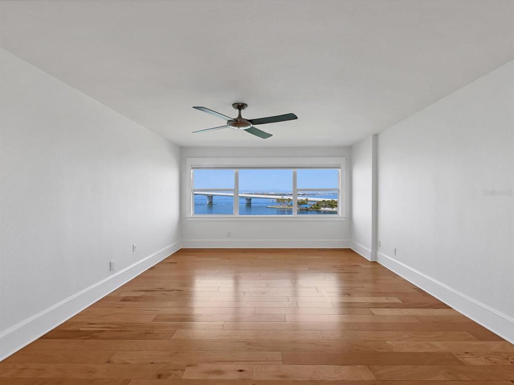 226 Golden Gate Point, Unit 63 Sarasota, FL 34236 - Photo 28 of 48 a view of a livingroom with wooden floor and a ceiling fan