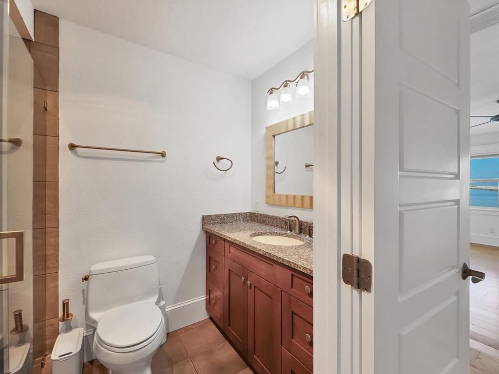 226 Golden Gate Point, Unit 63 Sarasota, FL 34236 - Photo 30 of 48 a bathroom with a granite countertop toilet and a sink