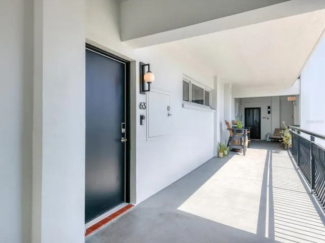 a hallway with a wooden floor and a large window