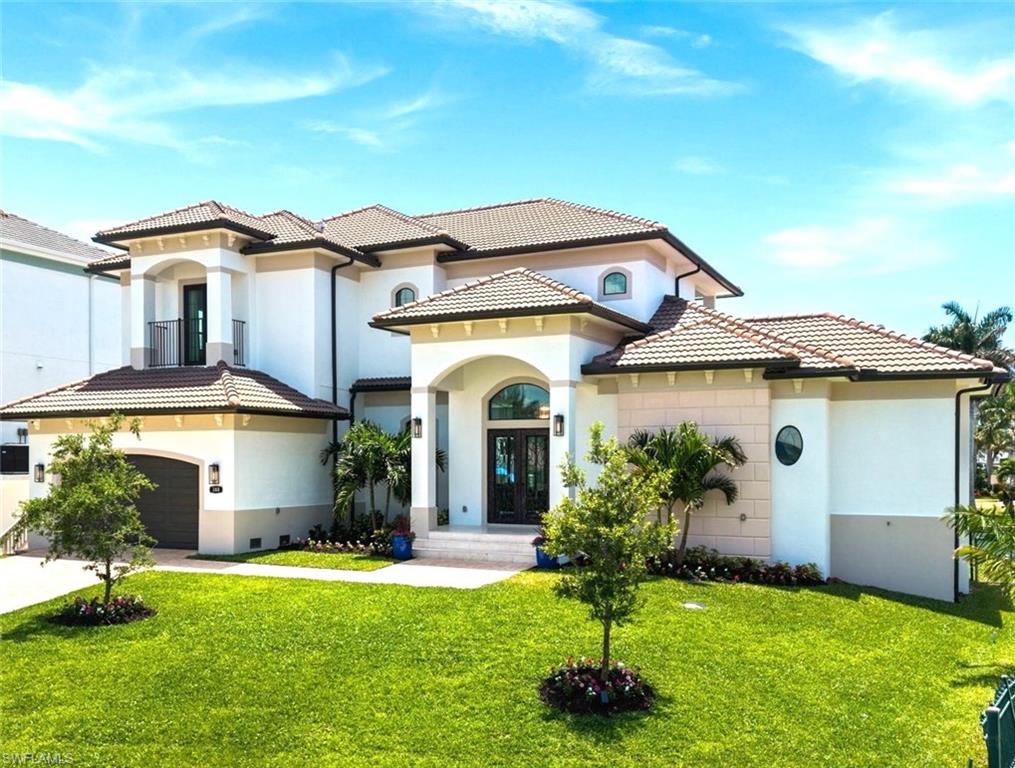388 Pine Avenue Naples, FL 34108 - Photo 11 of 34 a front view of a house with a garden and plants