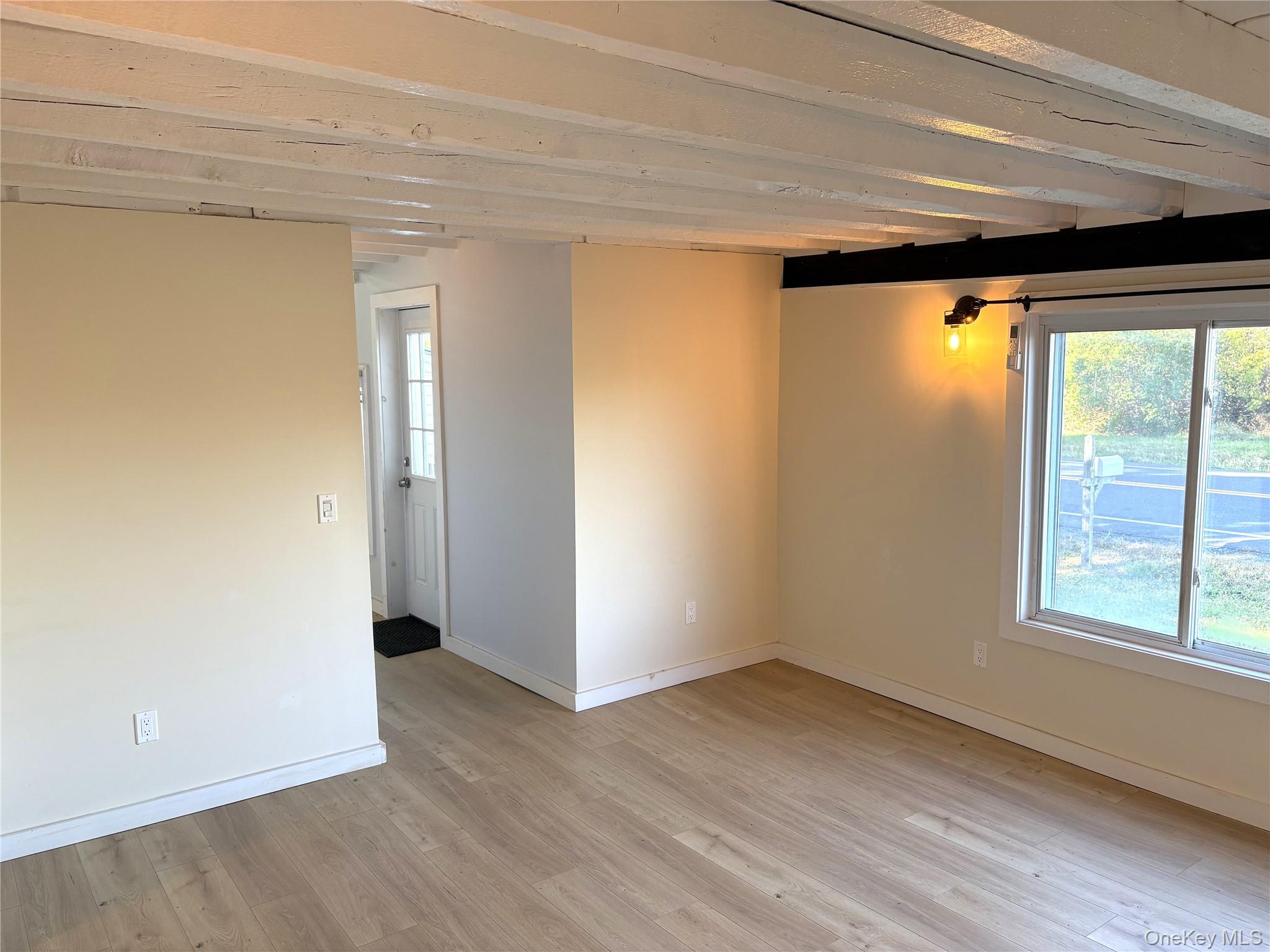 351 Co Rte 19 Hudson, NY 12534 - Photo 16 of 26 a view of an empty room with wooden floor and a window
