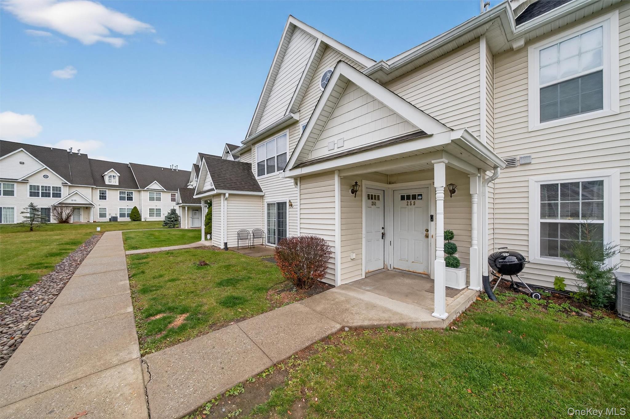 a front view of house with yard and outdoor seating