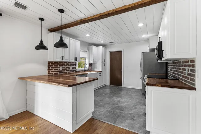 a kitchen with granite countertop a sink and a stove