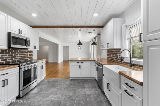 a kitchen with stainless steel appliances granite countertop a stove and a sink