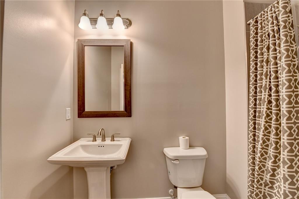 3445 Benedict Place Suwanee, GA 30024 - Photo 28 of 59 a bathroom with a sink mirror and toilet