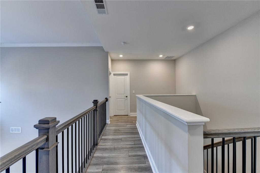 3445 Benedict Place Suwanee, GA 30024 - Photo 30 of 59 a view of a hallway with wooden floor