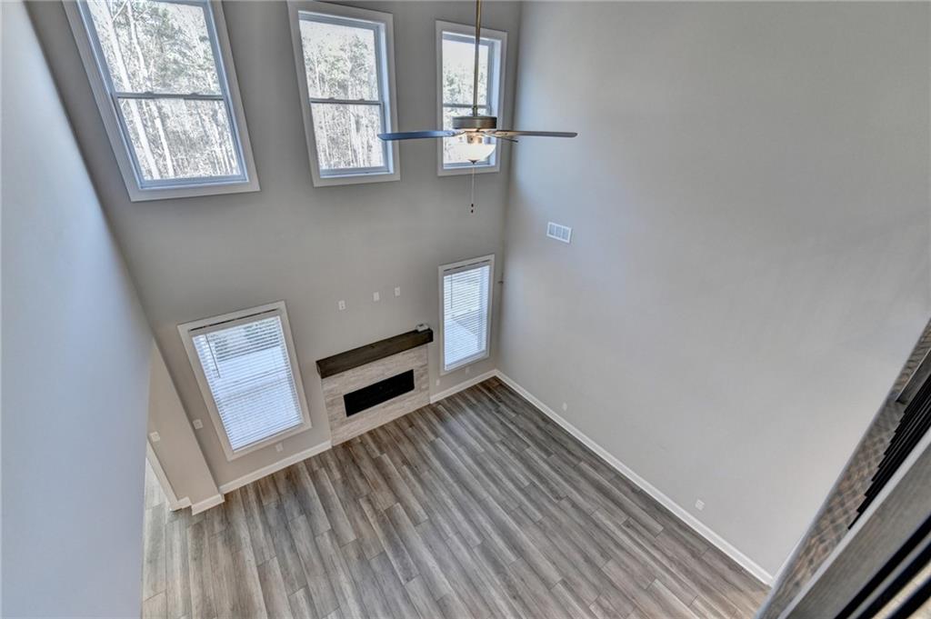 3445 Benedict Place Suwanee, GA 30024 - Photo 31 of 59 a view of an empty room with wooden floor and a window