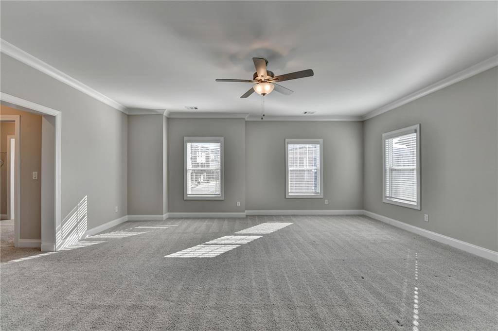 3445 Benedict Place Suwanee, GA 30024 - Photo 32 of 59 a view of a livingroom with a ceiling fan and window