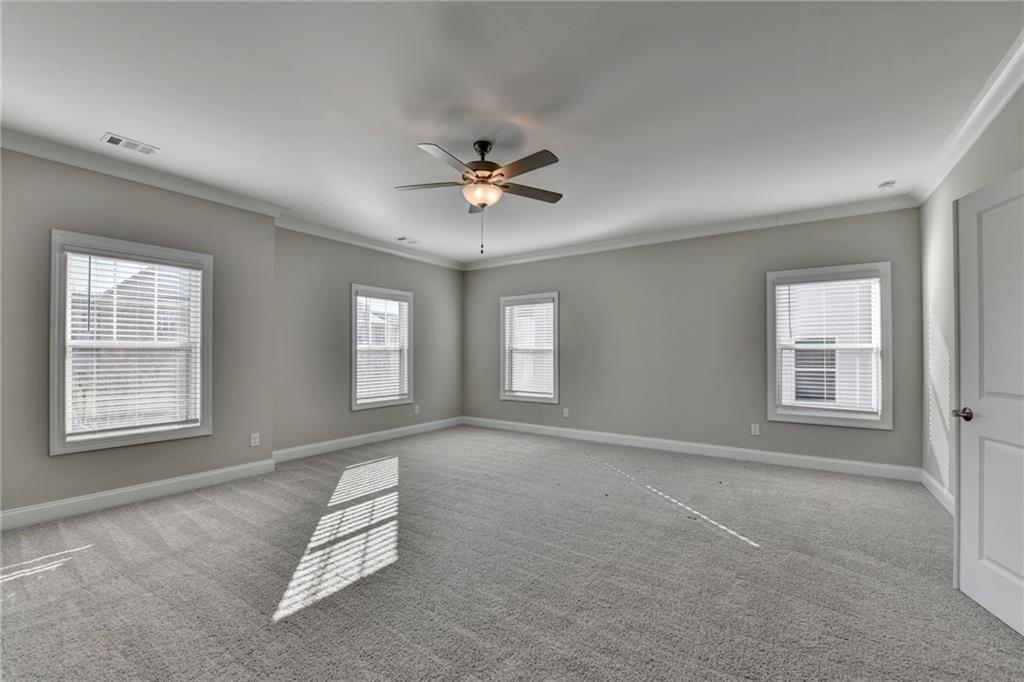 3445 Benedict Place Suwanee, GA 30024 - Photo 33 of 59 a living room with furniture and a ceiling fan