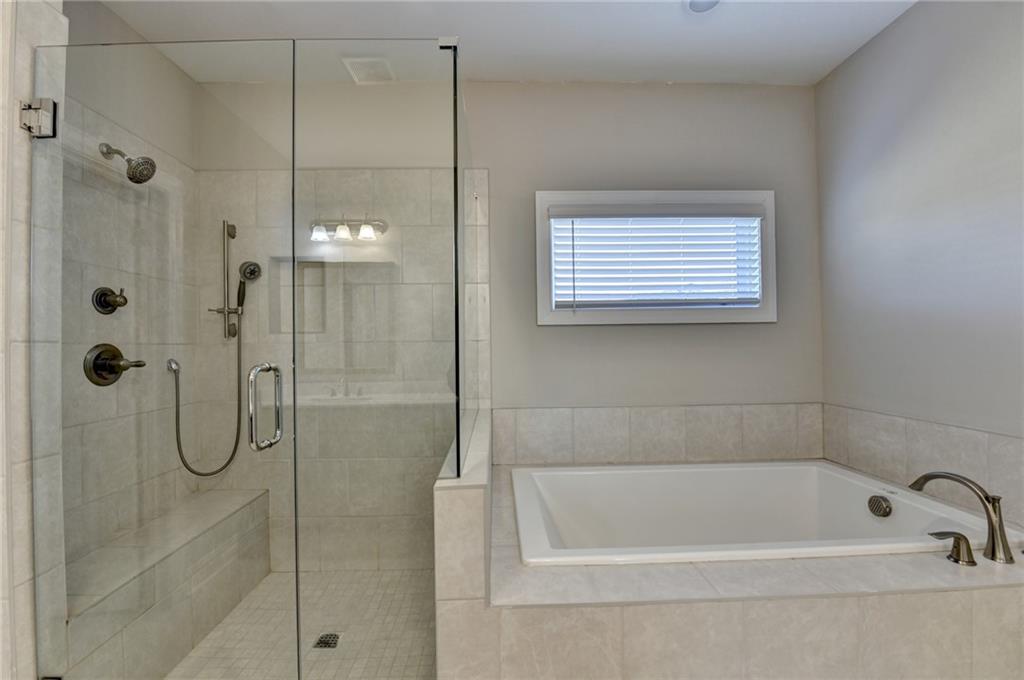 3445 Benedict Place Suwanee, GA 30024 - Photo 39 of 59 a bathroom with a bath tub and shower