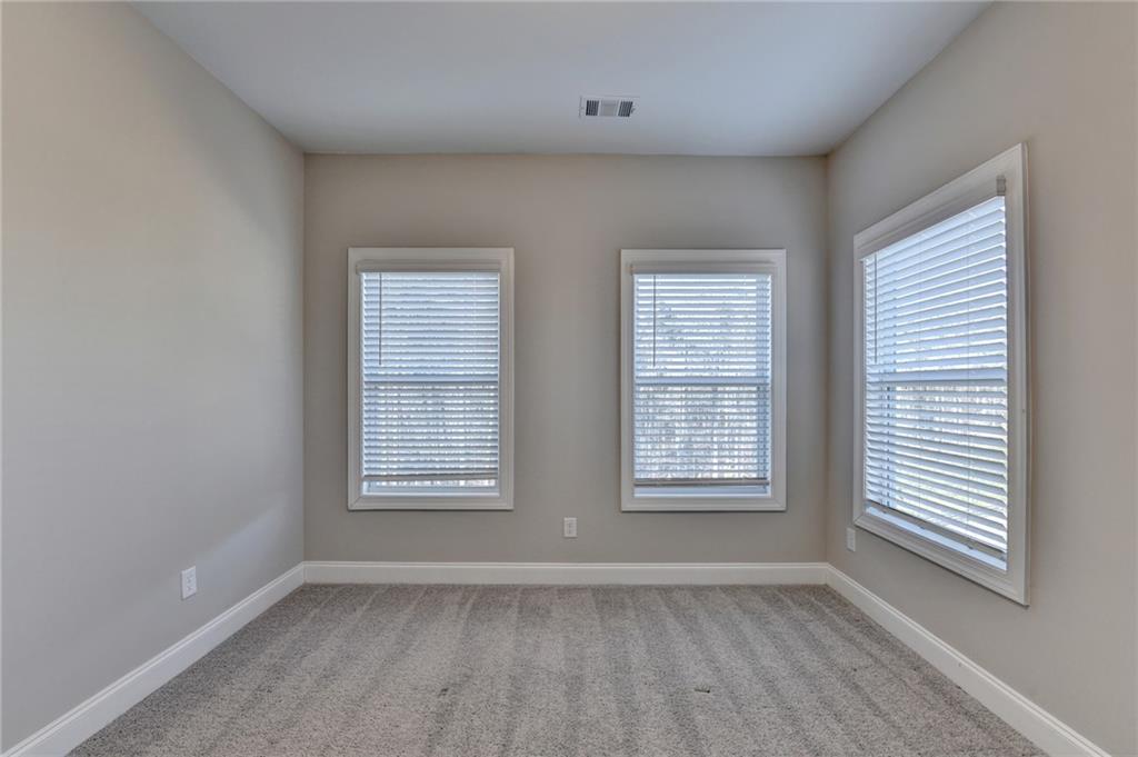 3445 Benedict Place Suwanee, GA 30024 - Photo 46 of 59 an empty room with wooden floor and windows