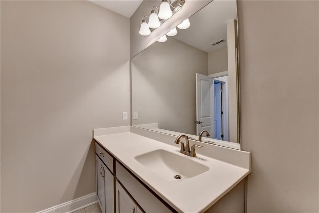3445 Benedict Place Suwanee, GA 30024 - Photo 48 of 59 a bathroom with a sink and a mirror