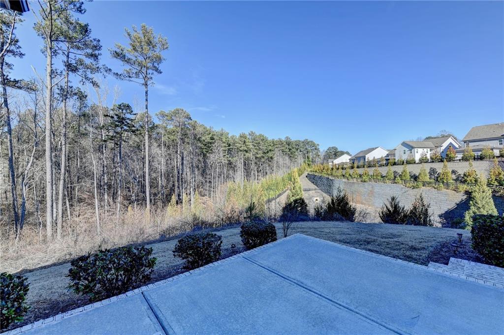 3445 Benedict Place Suwanee, GA 30024 - Photo 49 of 59 a view of a pathway with a wrought fence